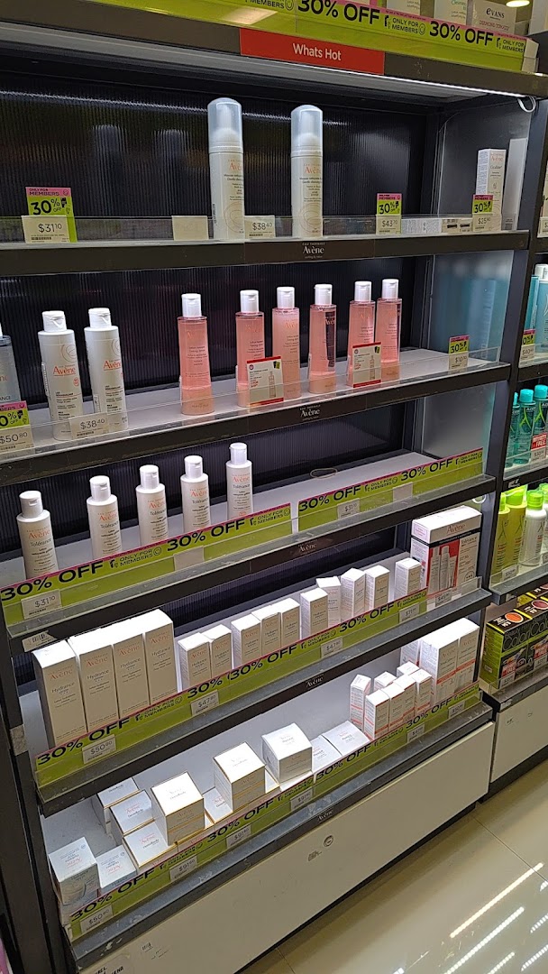 A retail display shelf showcasing various Avene skincare products with prominent 30% off signs.