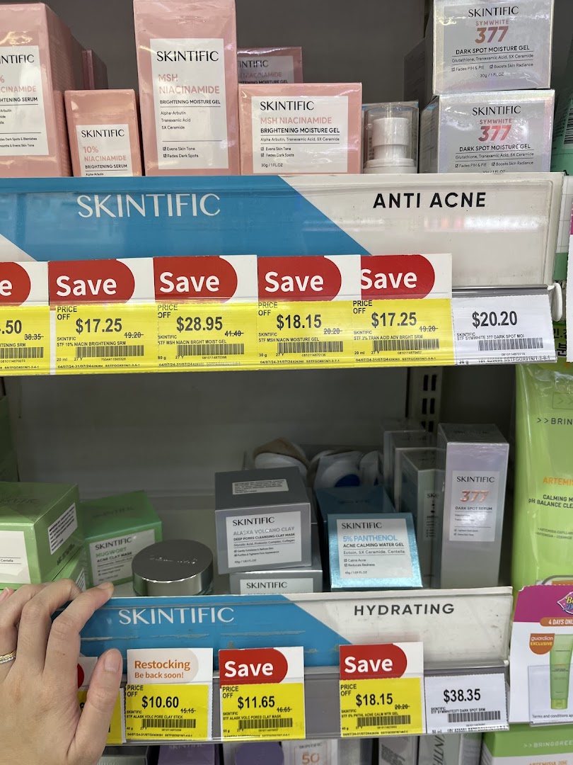 A close-up view of Skintific skincare products on display shelves with sale prices.