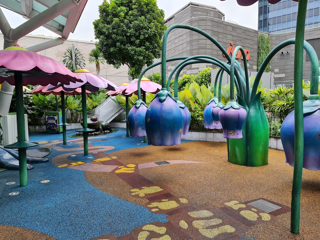 A vibrant outdoor play area with colorful flower and plant-themed structures for children.