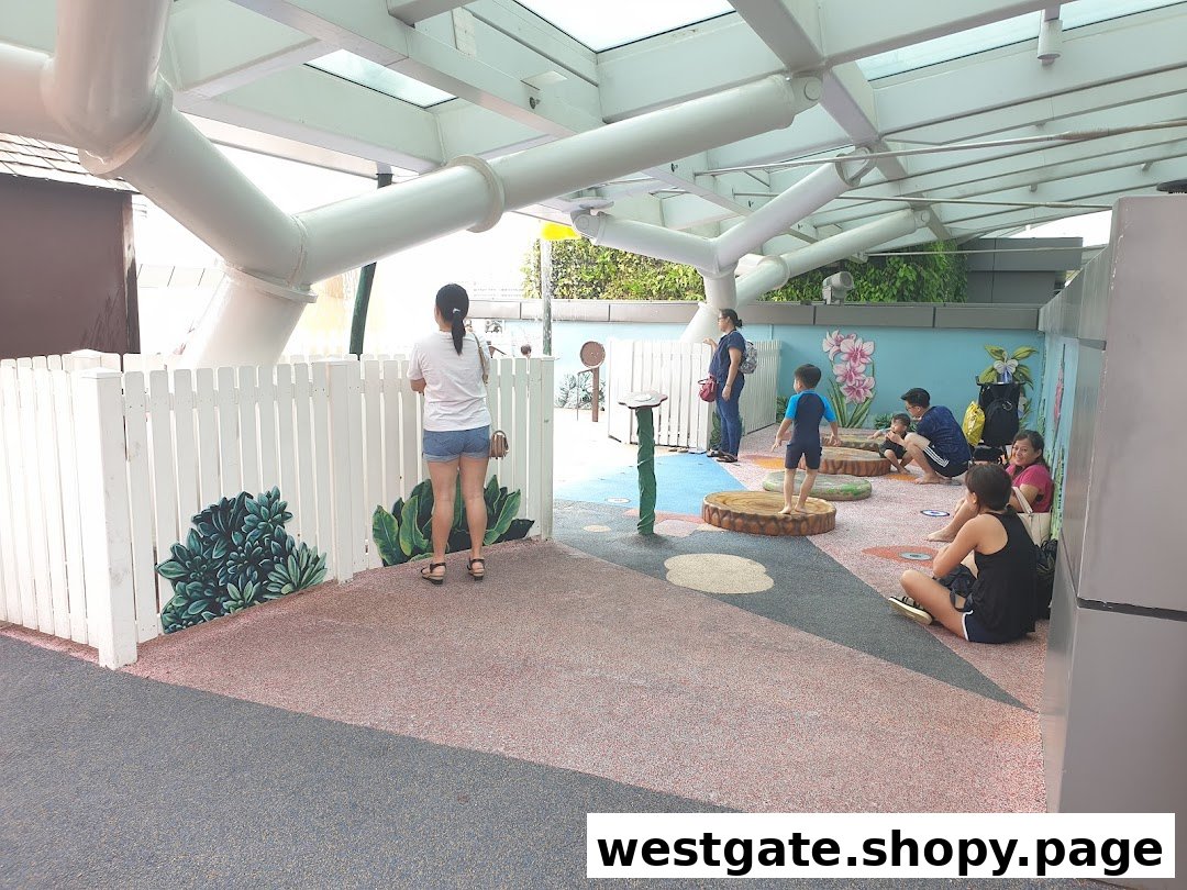 Families and children enjoy a vibrant indoor play area with soft flooring and interactive elements.
