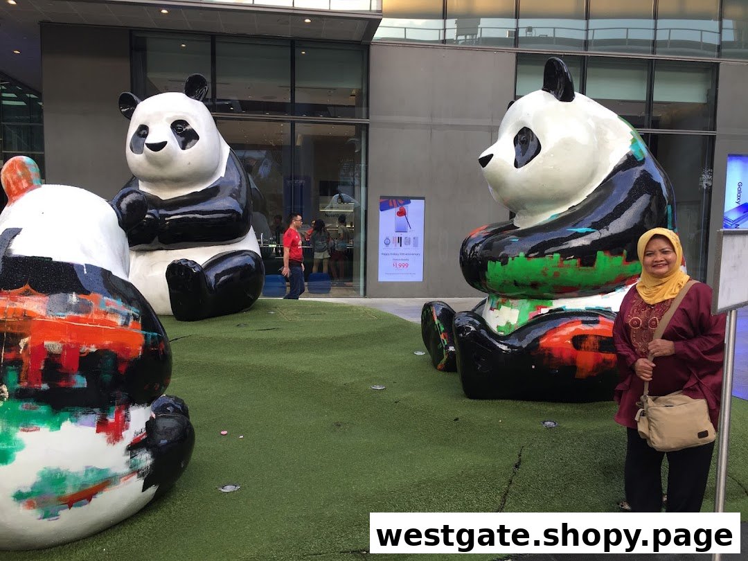 Large, colorful panda statues on artificial grass outside a modern building with a woman smiling.