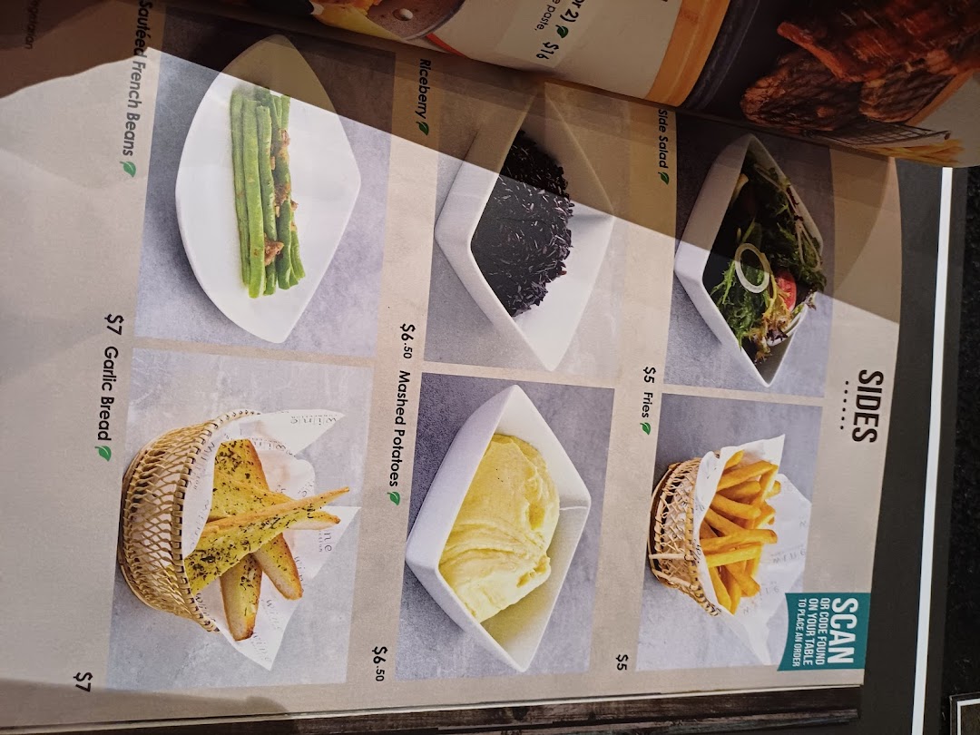 A close-up of a restaurant menu page displaying various side dishes with some prices.
