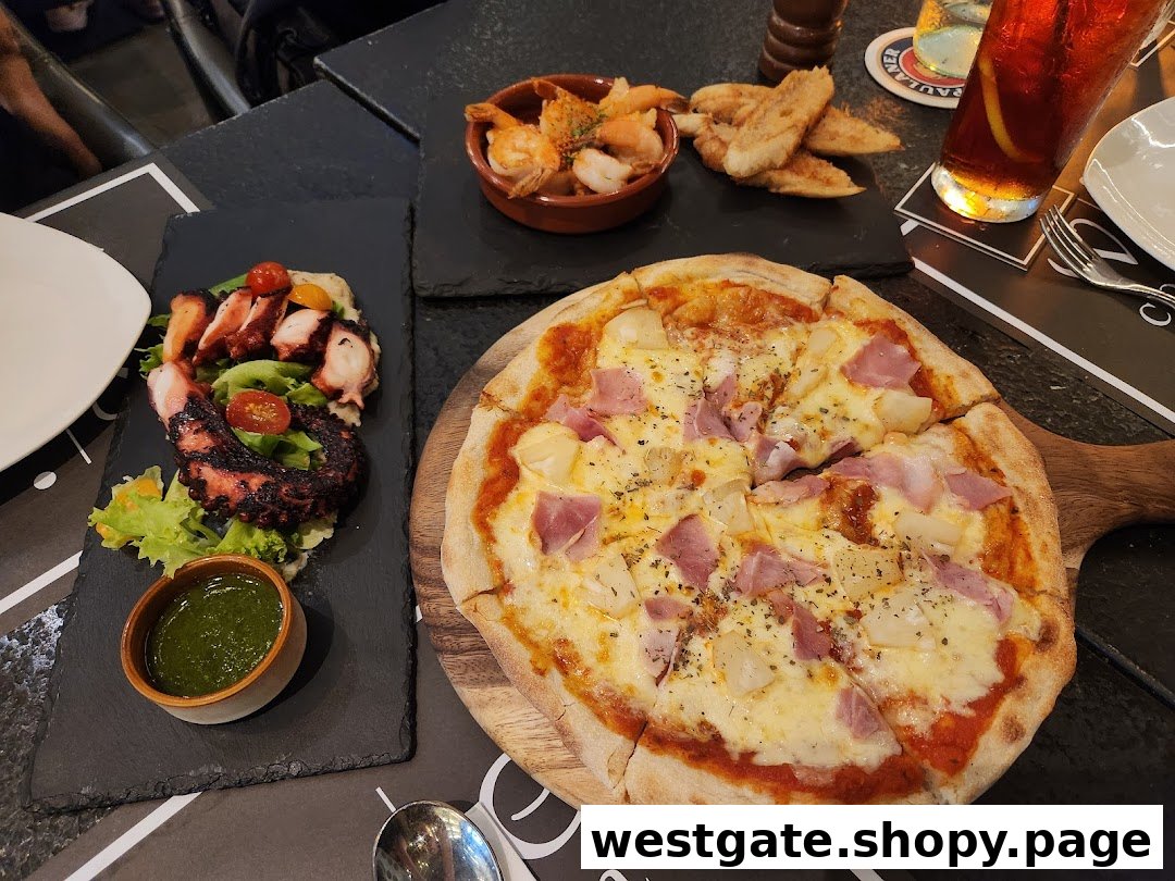A table laden with a delicious pizza, grilled octopus salad, and various appetizers at Wine Connection Bistro.