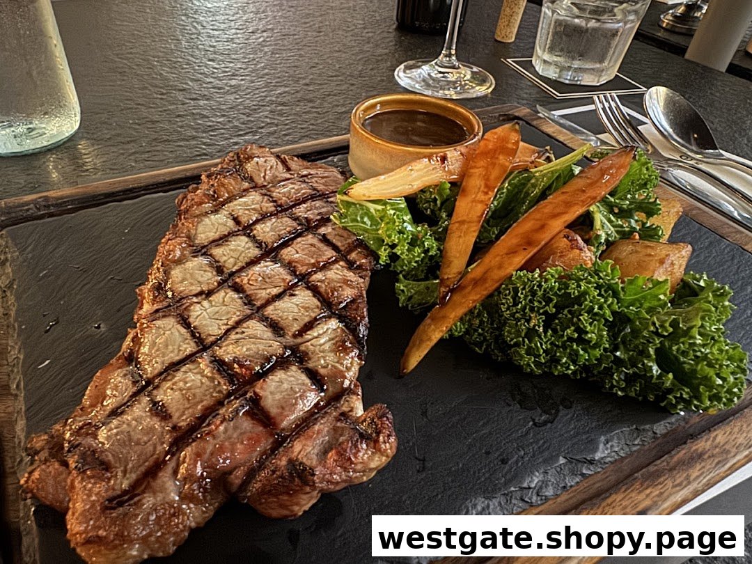 A perfectly grilled steak served with roasted vegetables and a side of sauce on a dark slate board.