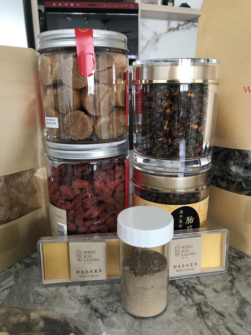 Assortment of traditional health products, including goji berries and cordyceps, in jars and packaging.