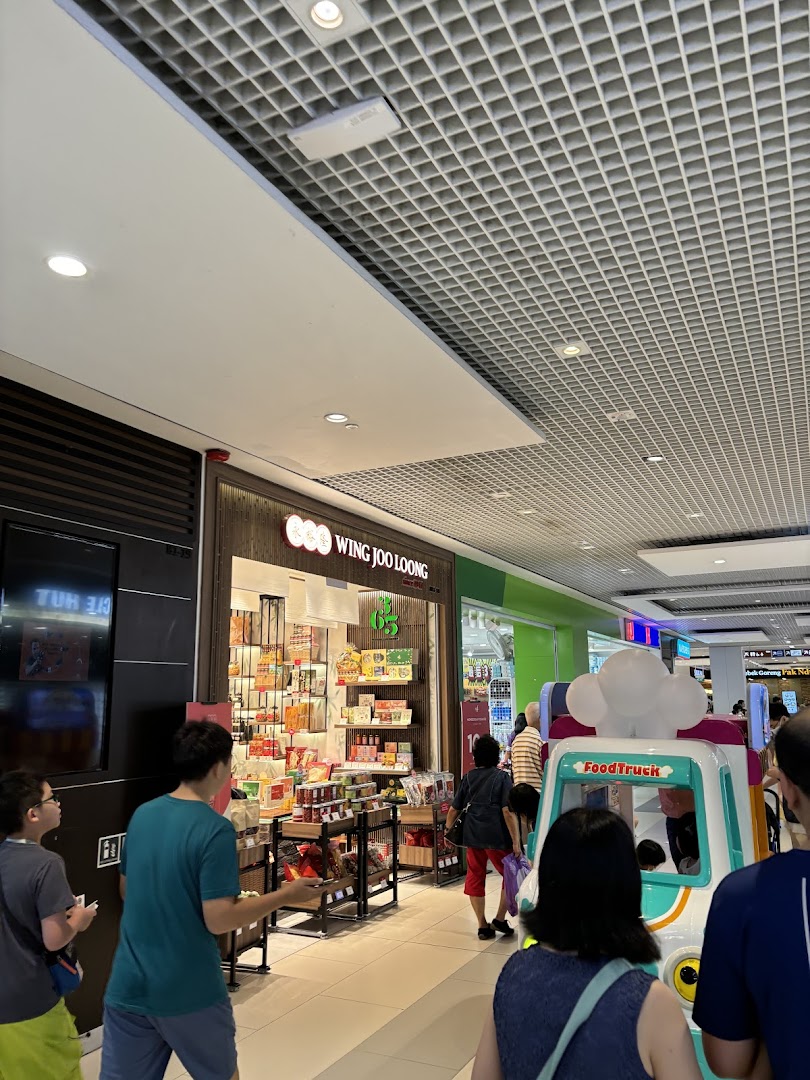 The storefront of Wing Joo Loong, a specialty food shop, within a bustling shopping mall.