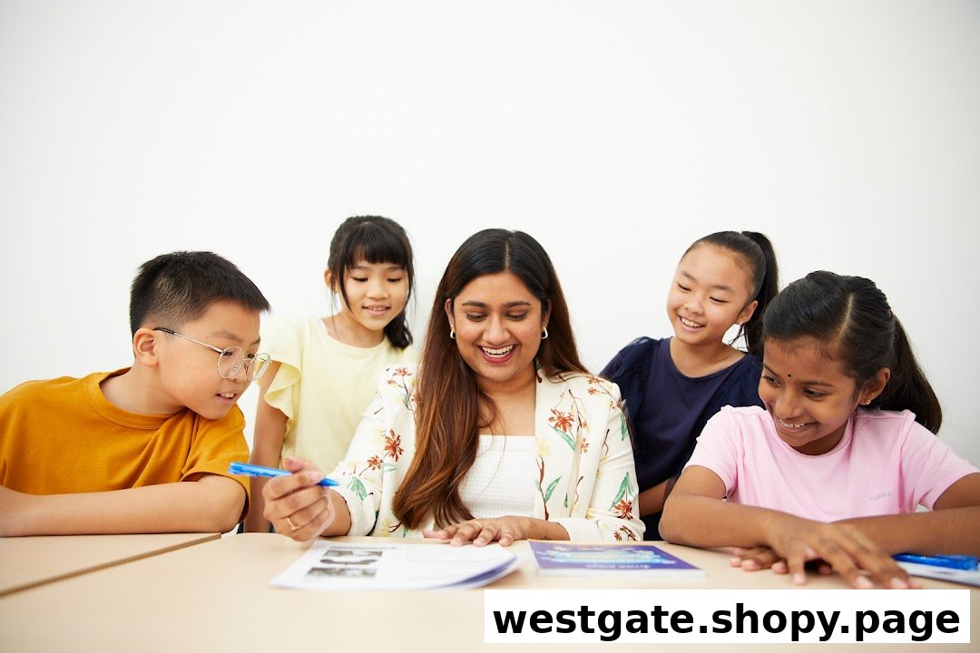 A teacher smiles while engaging with four diverse students at a learning table.