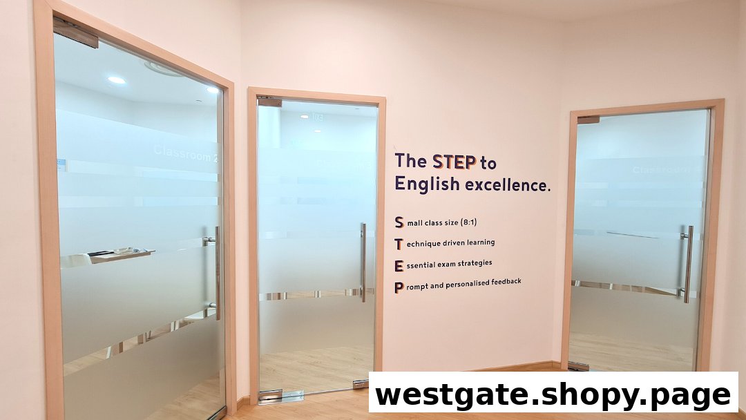 Interior view of Write Edge Westgate, featuring frosted glass classroom doors and a wall promoting English excellence.