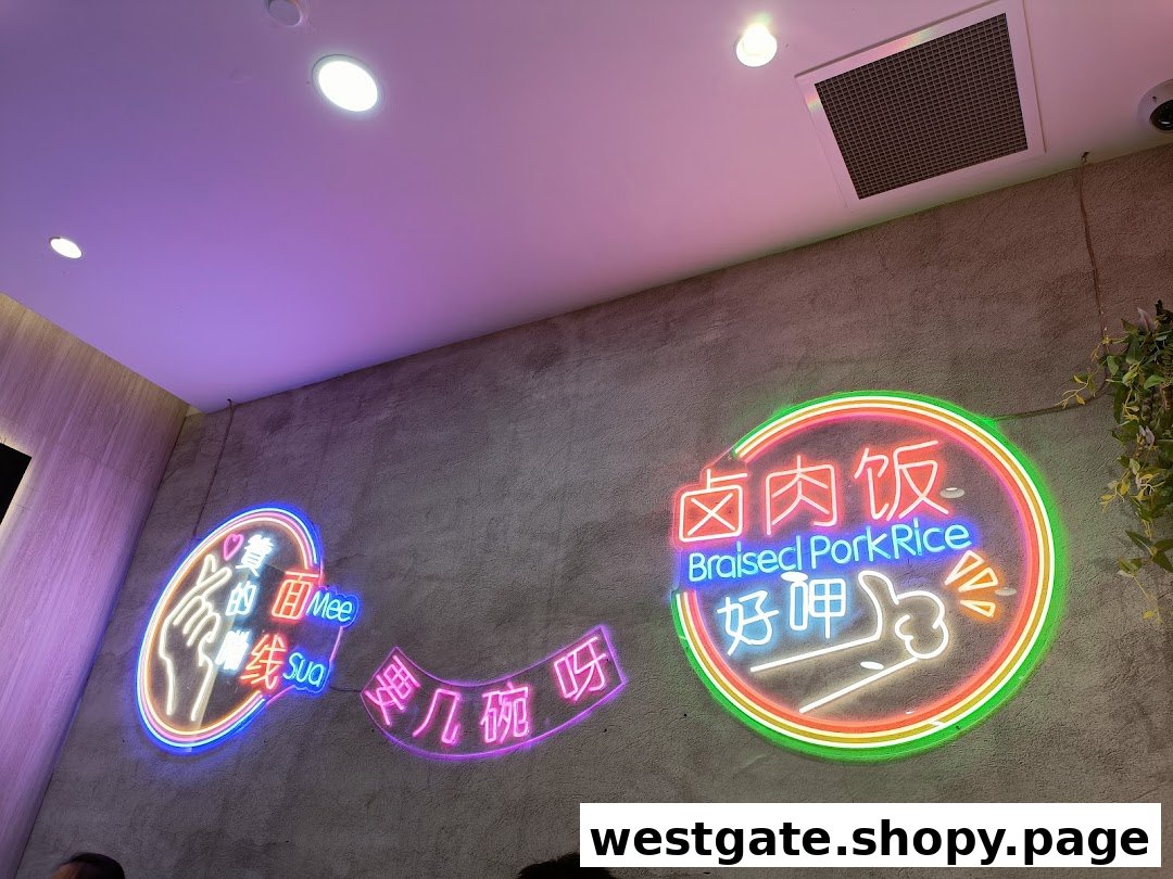 Vibrant neon signs on a textured wall, featuring 'Braised Pork Rice' and 'Mee Sua' in a modern setting.