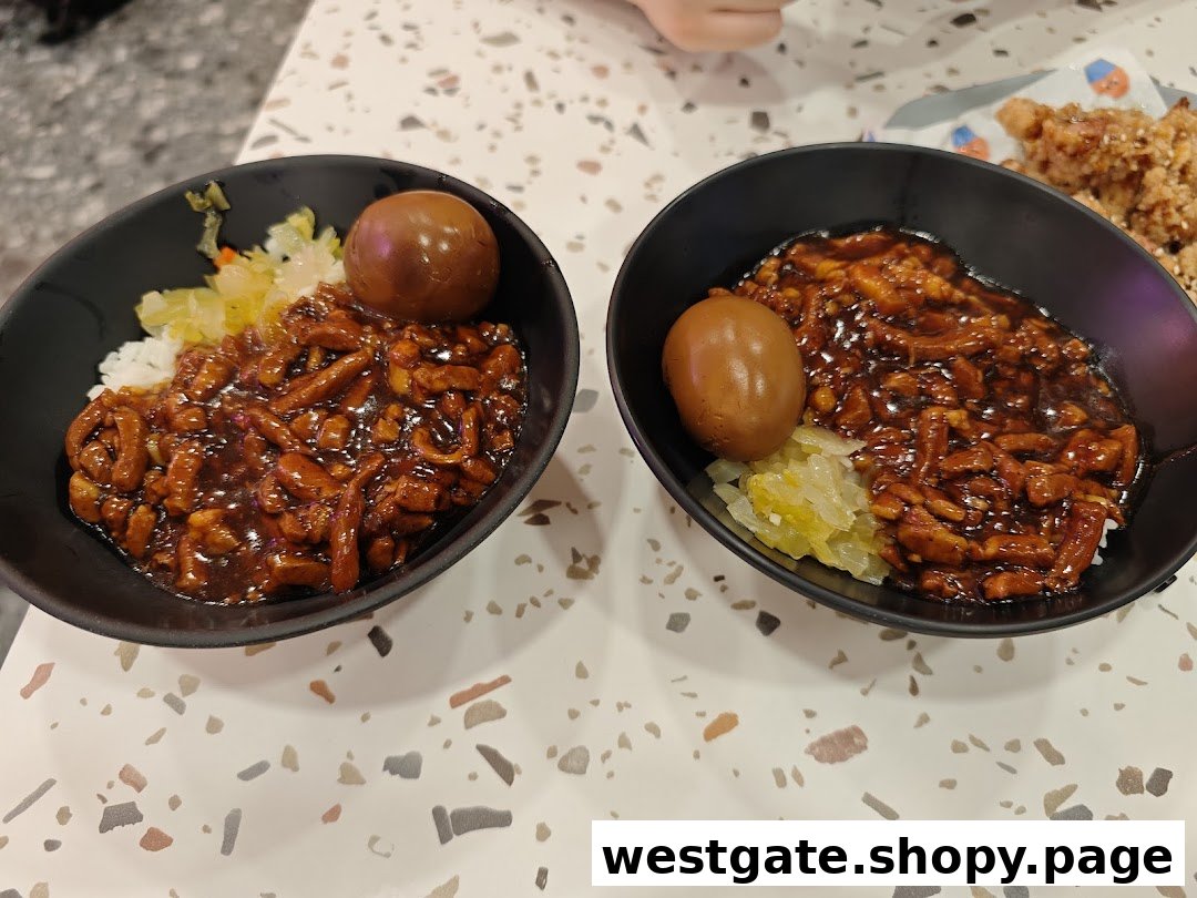 Two bowls of delicious Taiwanese braised pork rice (Lu Rou Fan) with a braised egg and pickled vegetables.