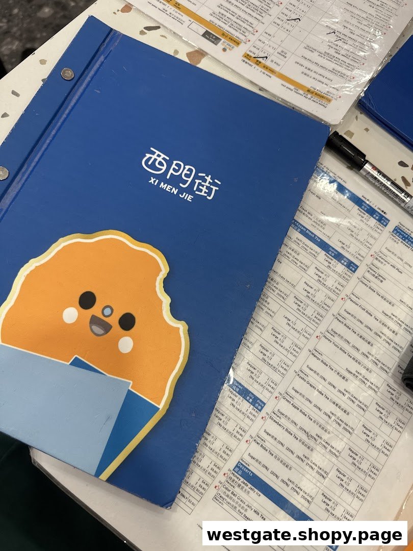 A blue menu booklet for Xi Men Jie and laminated menu sheets displaying various Taiwanese drinks and desserts.
