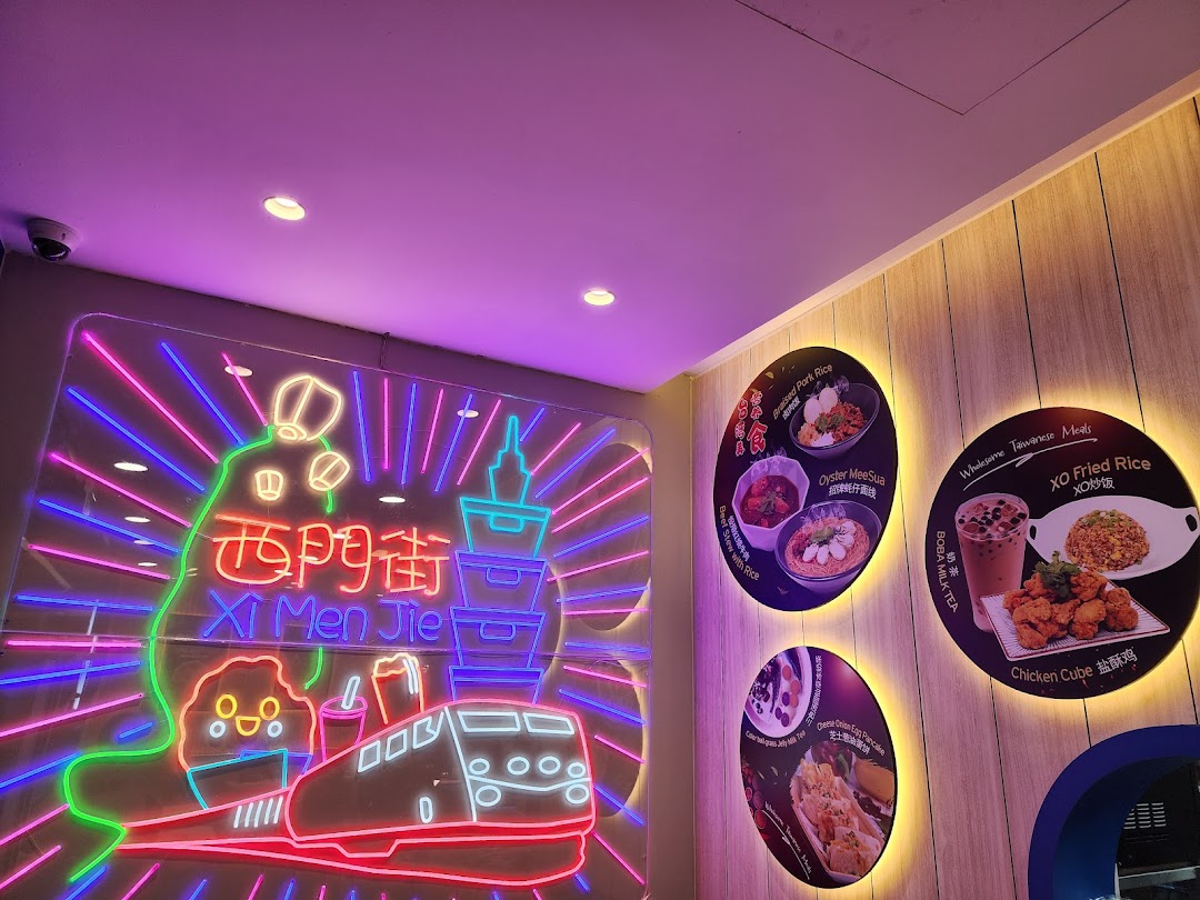Vibrant neon sign and illuminated displays showcasing Taiwanese dishes and drinks at Xi Men Jie.