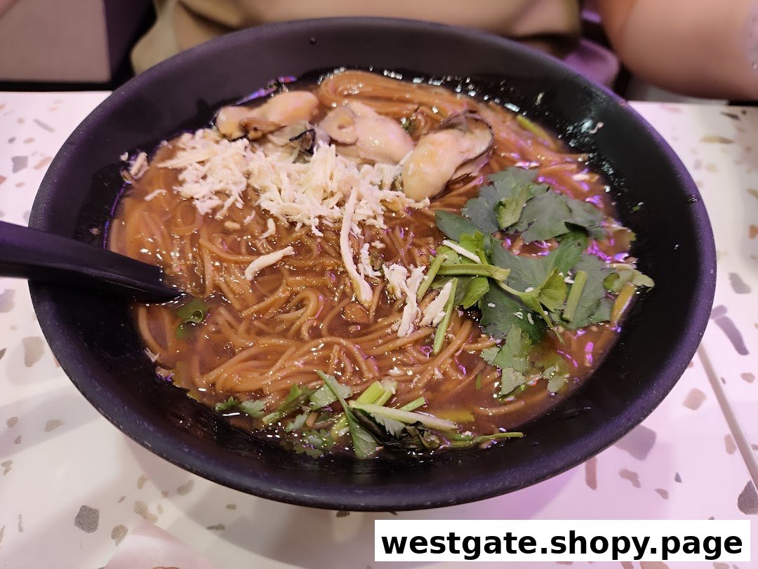 A close-up of a delicious bowl of Taiwanese oyster vermicelli with shredded toppings and fresh herbs.