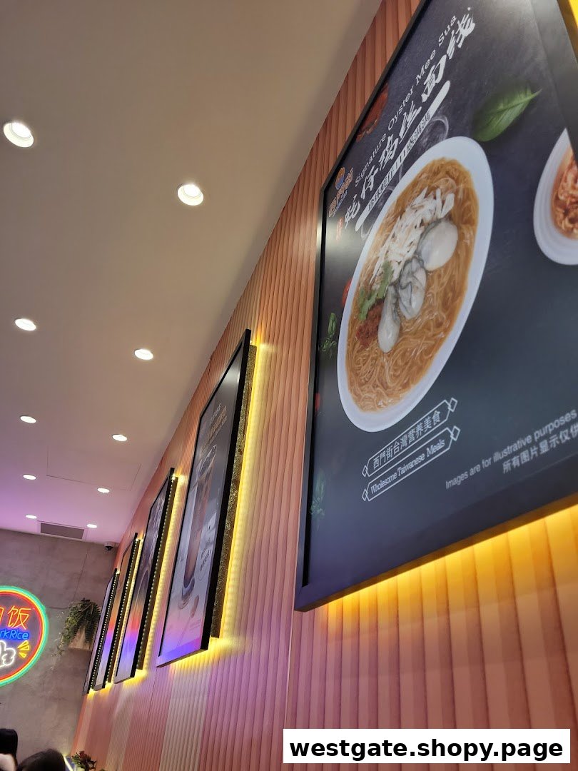 An interior shot of a Taiwanese restaurant featuring large, illuminated posters of signature dishes on a wooden wall.
