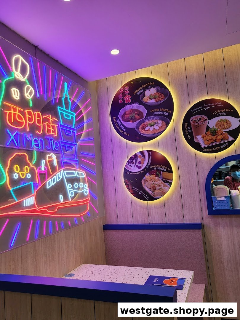 An inviting interior shot of Xi Men Jie, featuring a vibrant neon sign and illuminated food display boards.