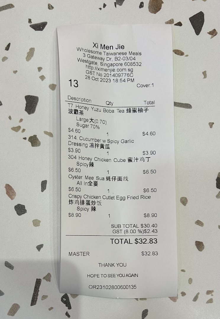 A detailed close-up of a receipt from Xi Men Jie, showcasing various Taiwanese meal items and their prices.