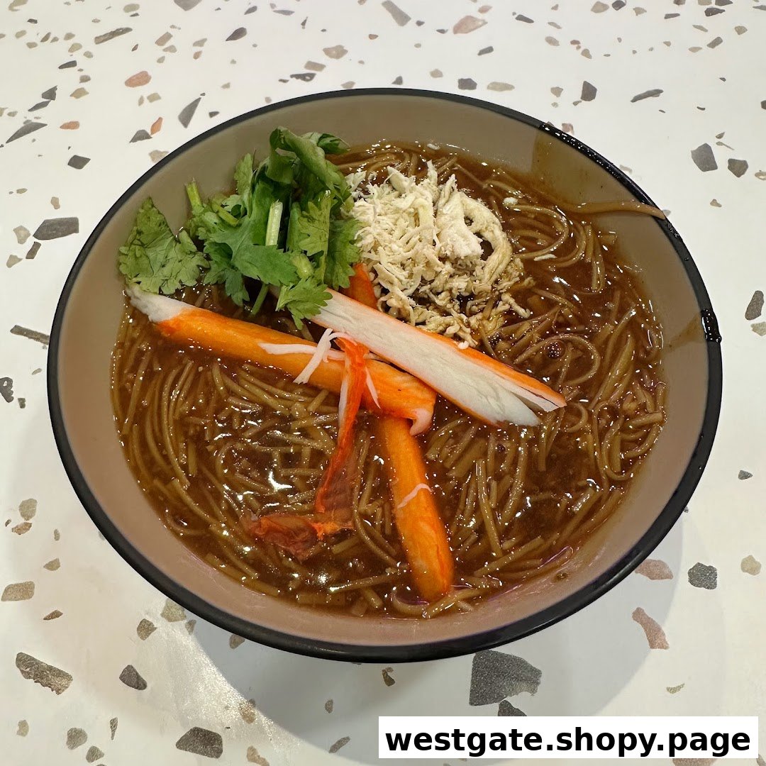 A close-up of a bowl of Taiwanese vermicelli with crab sticks, shredded meat, and cilantro.