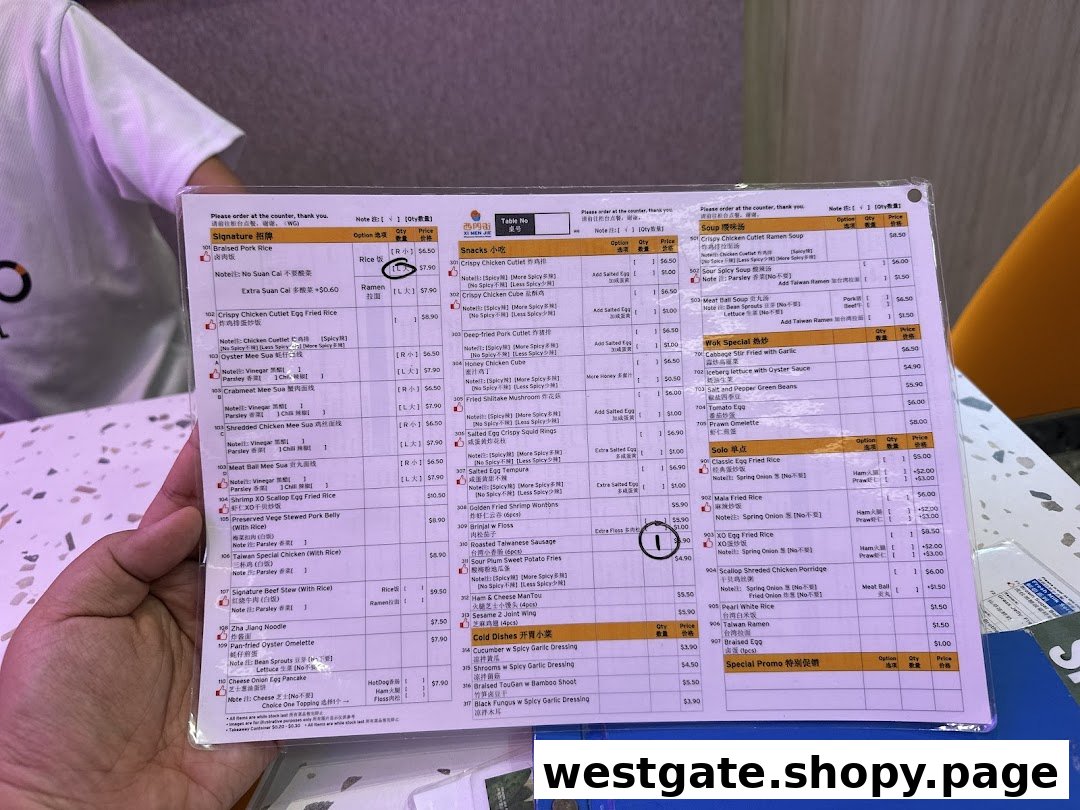 A close-up view of a laminated menu from Xi Men Jie, featuring various Taiwanese dishes and prices.