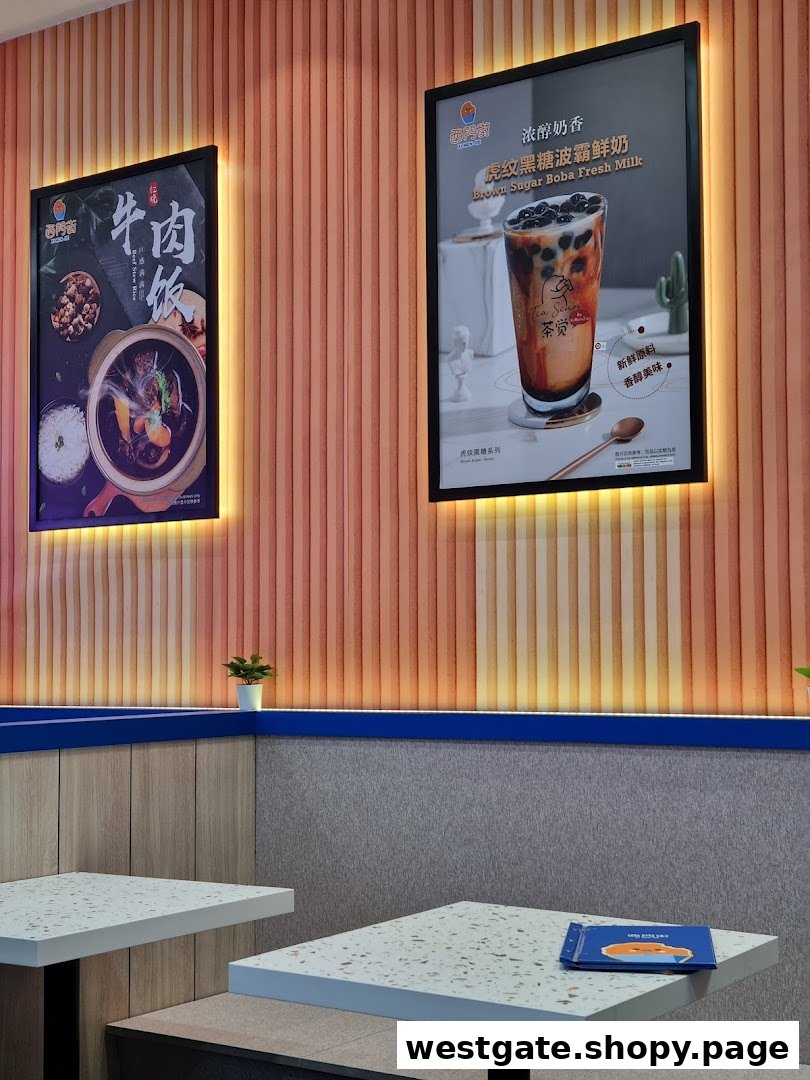 Interior view of Xi Men Jie featuring illuminated posters for beef rice and brown sugar boba fresh milk.