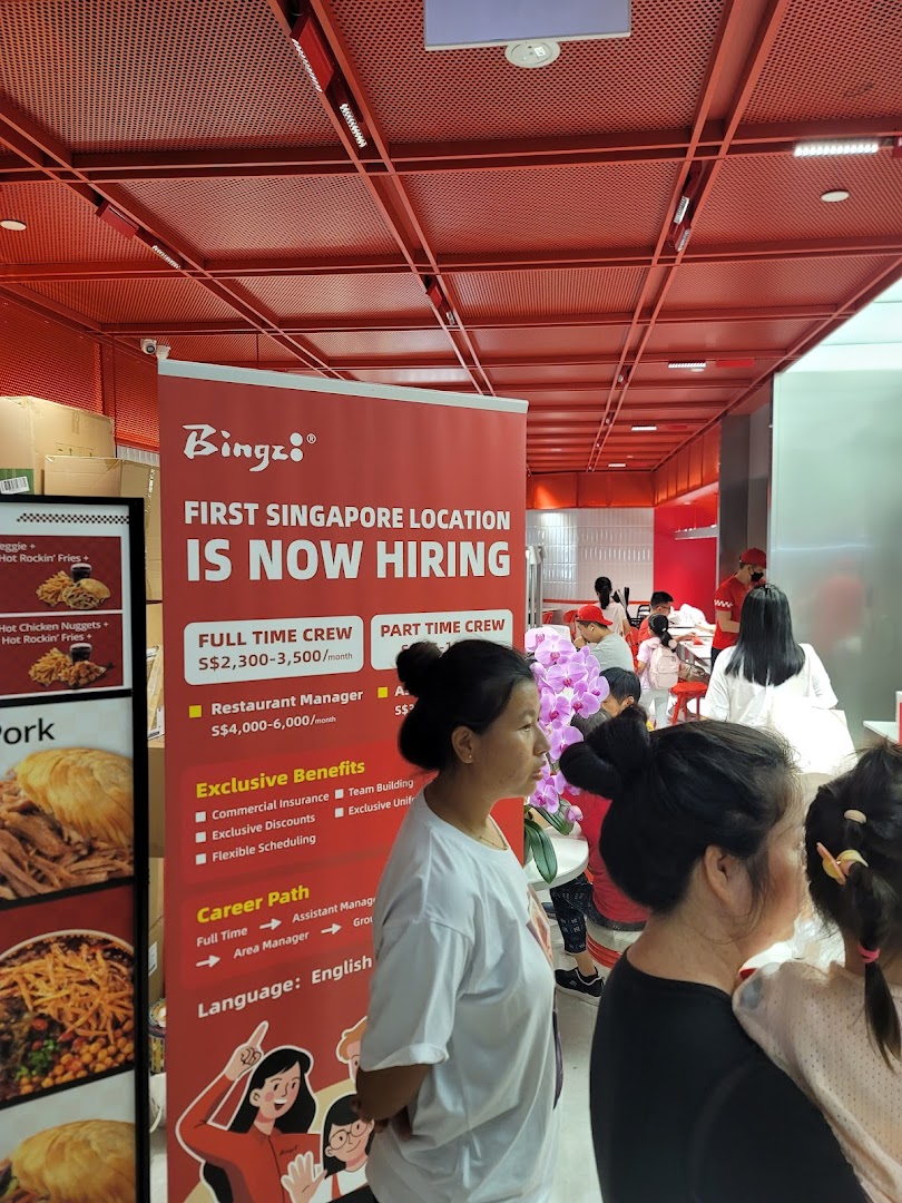 A restaurant interior featuring a prominent "Bingz" hiring banner and customers dining.