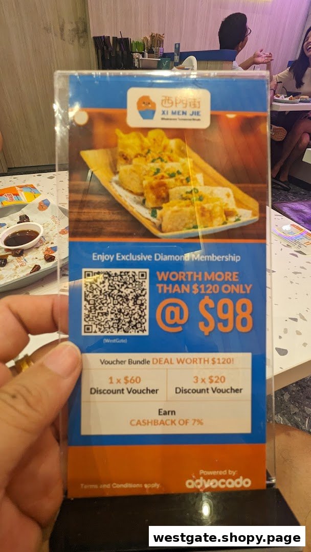 A hand holds a promotional standee for Xi Men Jie's Diamond Membership, featuring a food image and membership benefits.