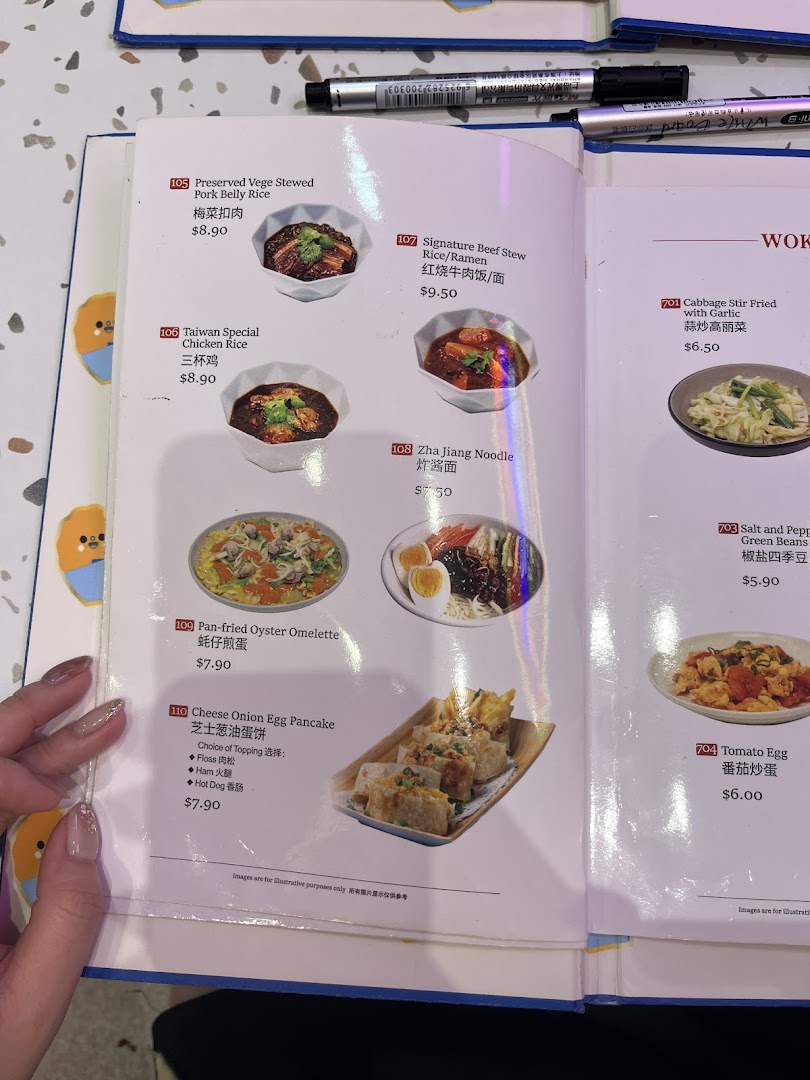 A close-up of a Taiwanese restaurant menu displaying various dishes with their names, descriptions, and prices.