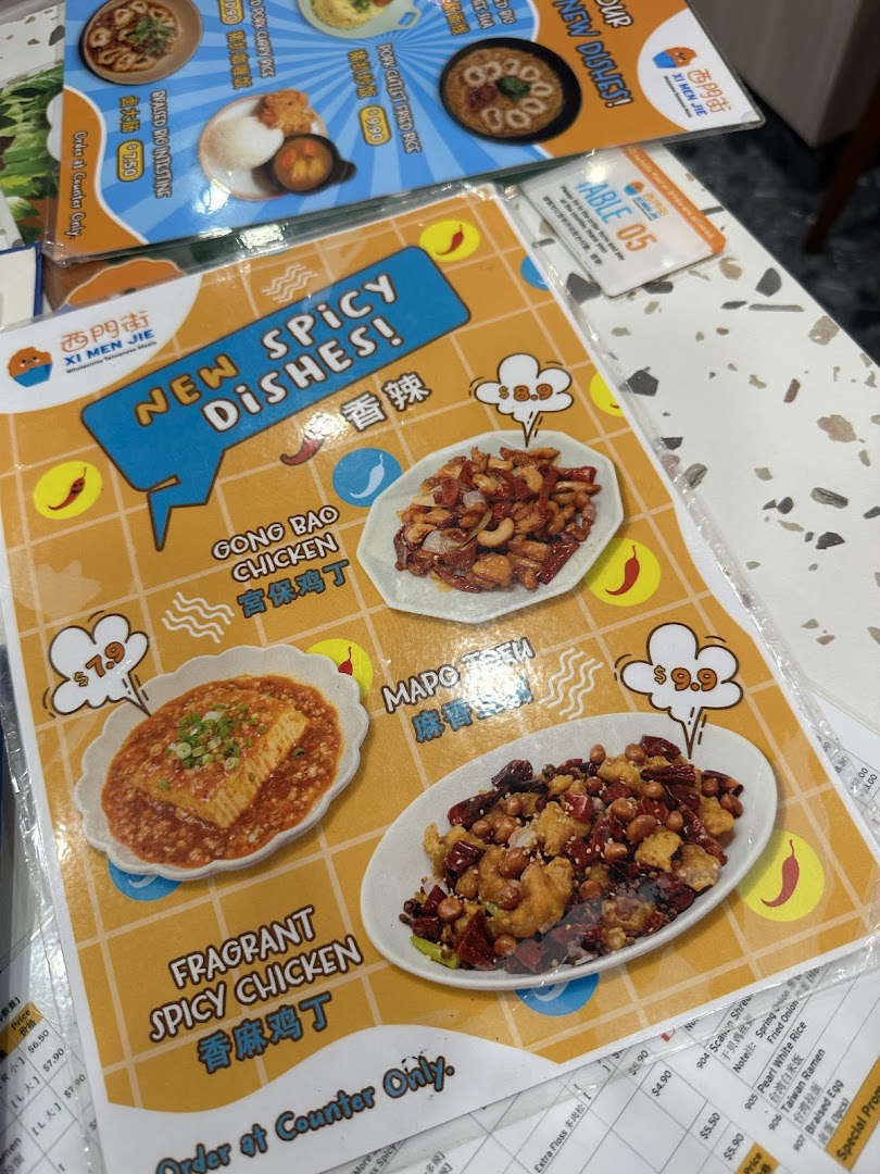 A close-up view of a menu displaying new spicy dishes and other Taiwanese meal options.