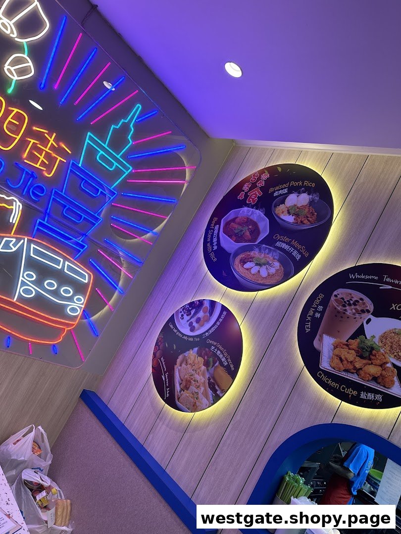 Interior view of Xi Men Jie featuring illuminated posters of Taiwanese dishes and a vibrant neon sign.