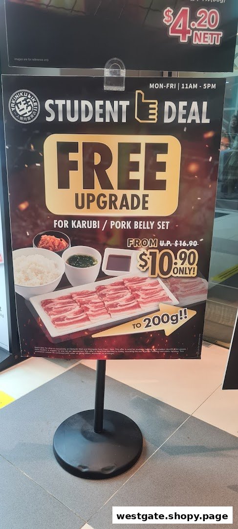A promotional stand advertising Yakiniku Like's student deal for Karubi/Pork Belly sets.