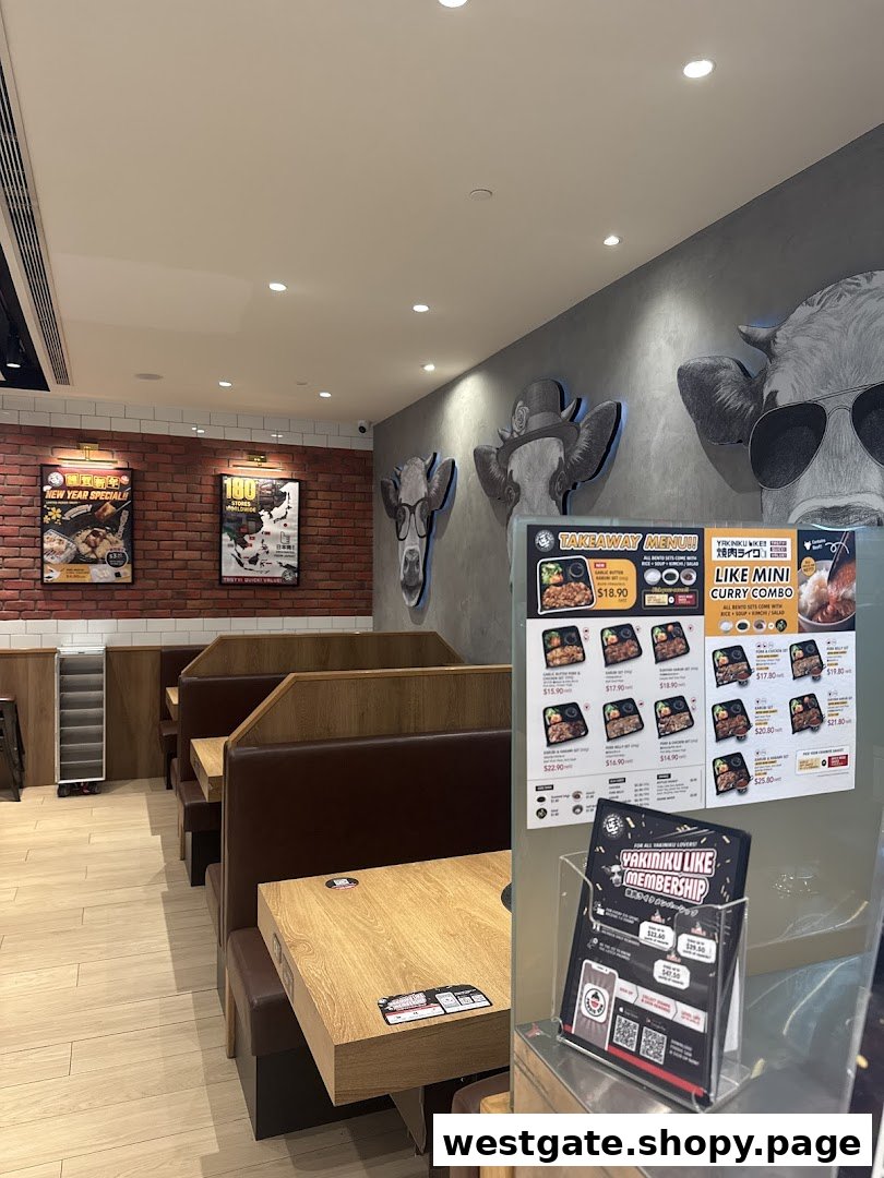 An inviting interior view of Yakiniku Like Westgate, featuring booth seating and unique cow-themed wall art.