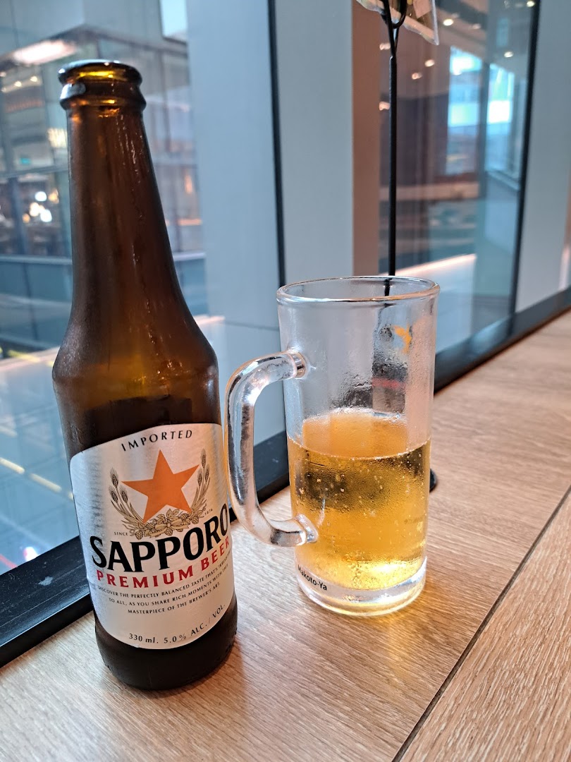 A chilled bottle of Sapporo Premium Beer next to a glass, ready to be enjoyed.