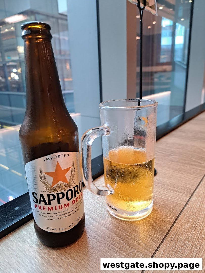A chilled bottle of Sapporo Premium Beer next to a glass, ready to be enjoyed.