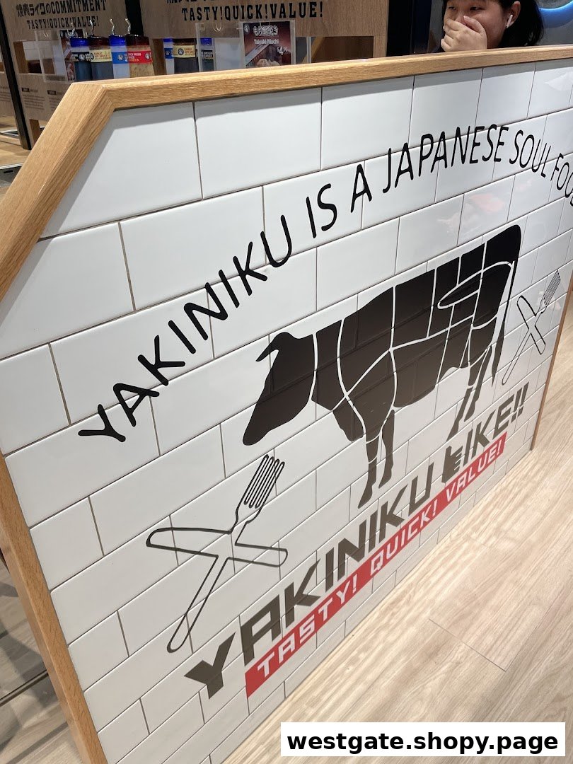 An interior shot of Yakiniku Like, featuring a tiled sign with a cow diagram and brand slogans.