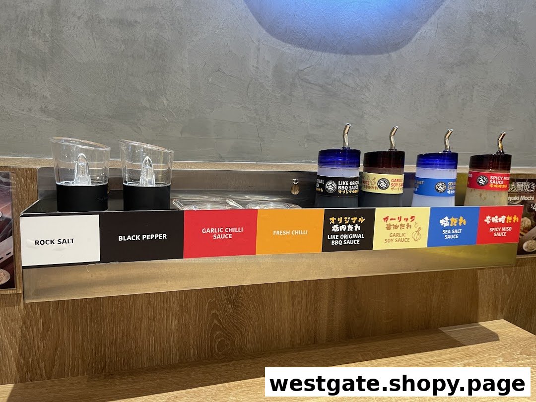 A variety of condiments including salt, pepper, and sauces available at a yakiniku restaurant counter.