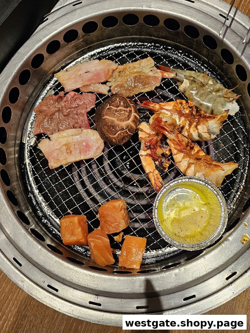 Various meats, seafood, and vegetables grilling on a yakiniku barbecue at Yakiniku Like.