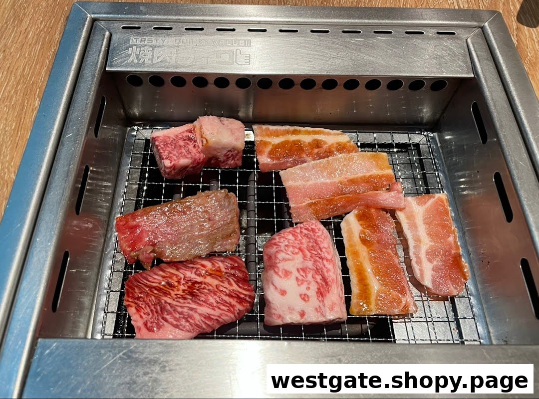 Assorted cuts of fresh yakiniku meat grilling on a personal tabletop grill.