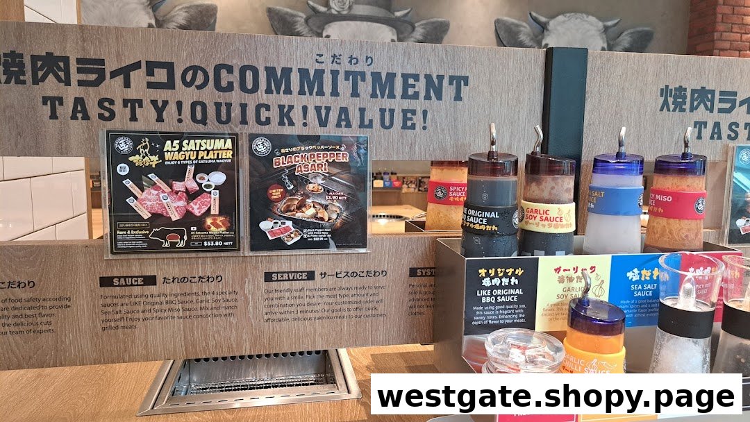 An interior view of Yakiniku Like, showcasing their sauce bar and promotional posters for wagyu and asari.