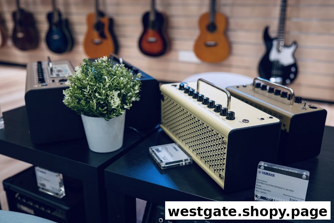 A display of Yamaha guitar amplifiers and a plant, with guitars visible in the background.