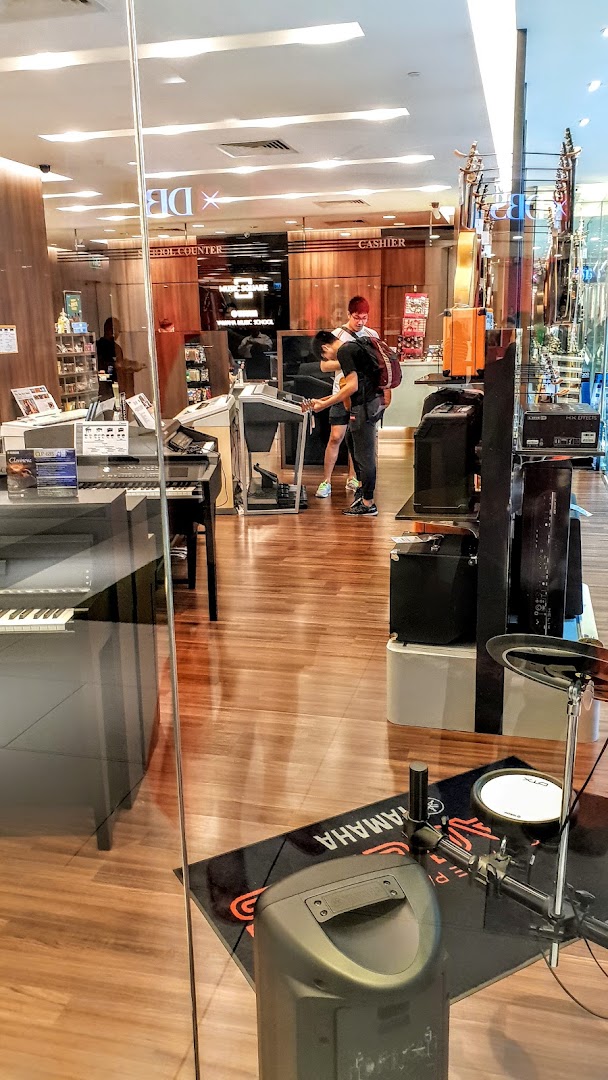 View into Yamaha Music Store showing customers browsing instruments and the school counter.