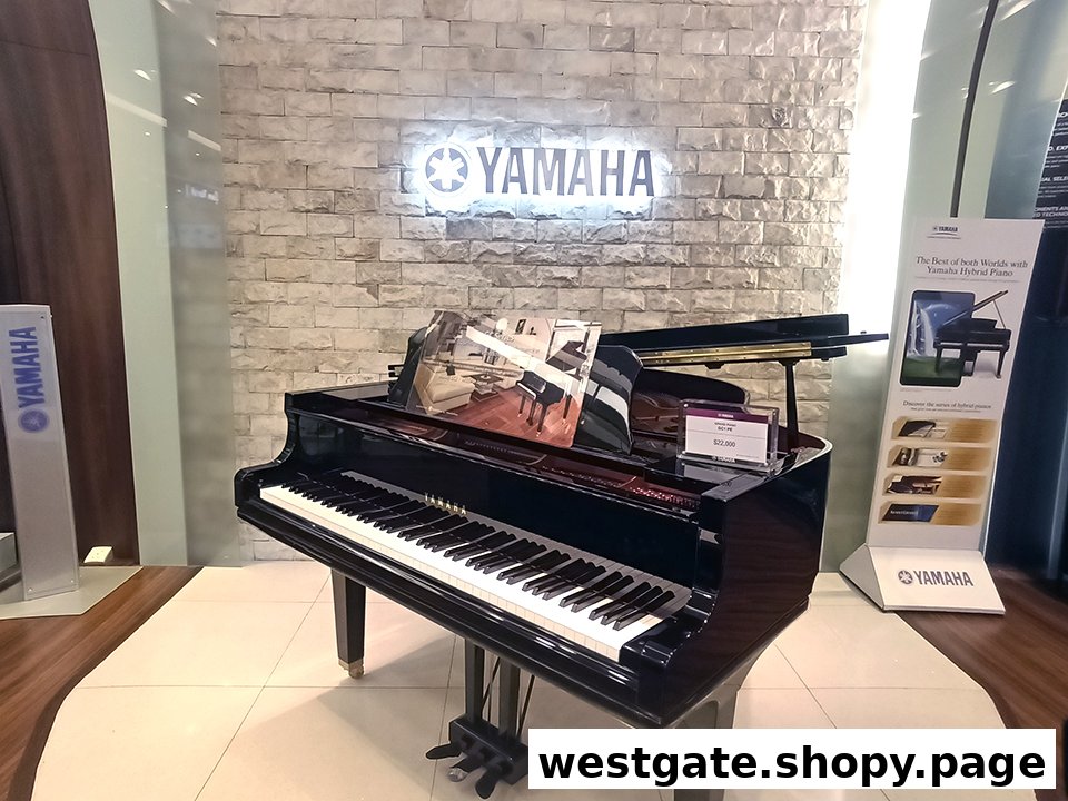 A sleek black grand piano displayed in a Yamaha Music Store, featuring a glowing logo.