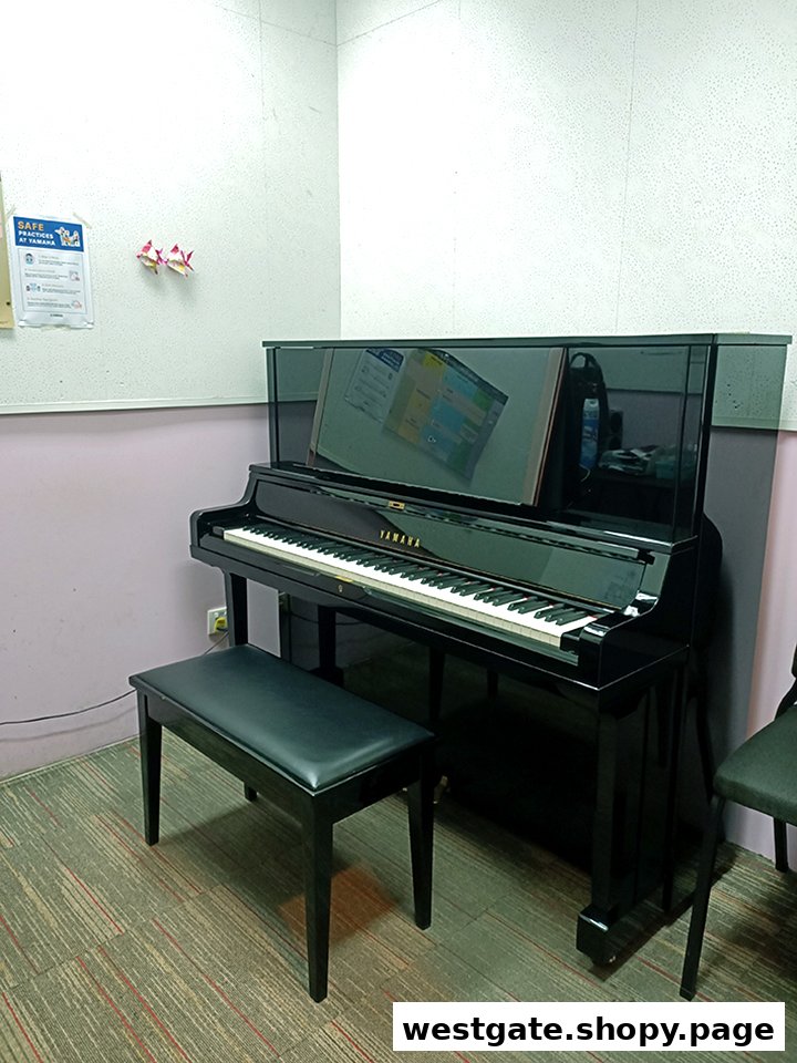 A black Yamaha upright piano with a bench in a music practice room.