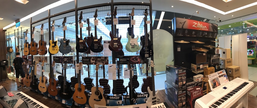 A wide selection of guitars, keyboards, and musical instruments displayed in a music store.
