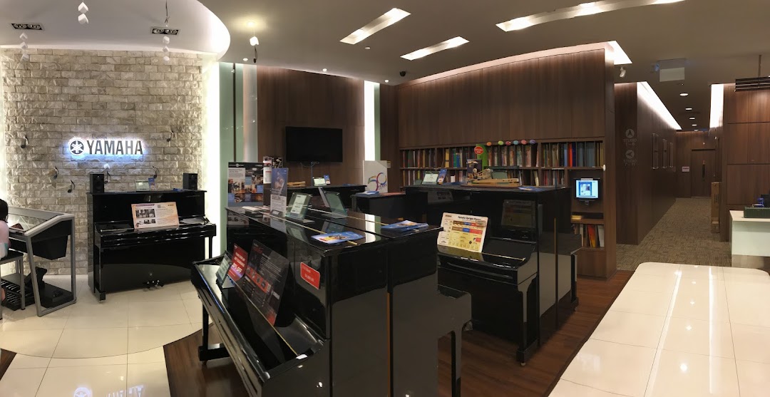 Interior view of the Yamaha Music Store, showcasing pianos and a music school area.