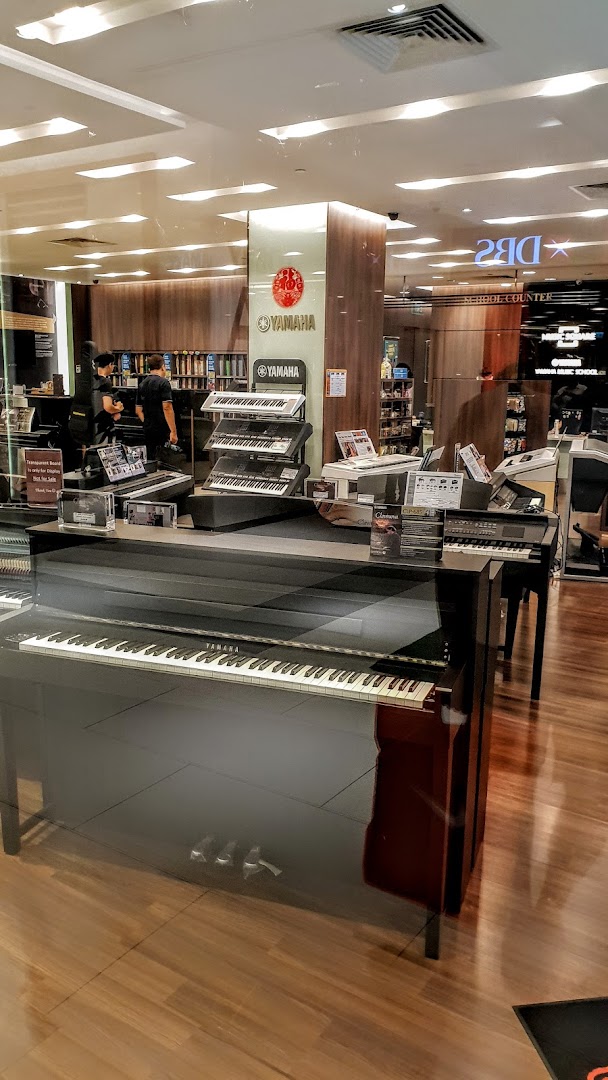 Interior view of Yamaha Music Store, showcasing pianos, keyboards, and staff.