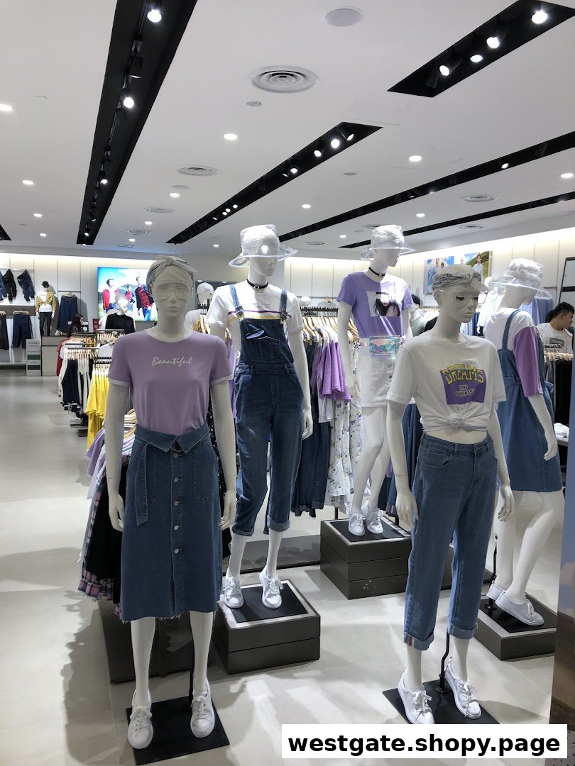 Mannequins display trendy casual wear, including denim and pastel tops, inside a bright clothing store.