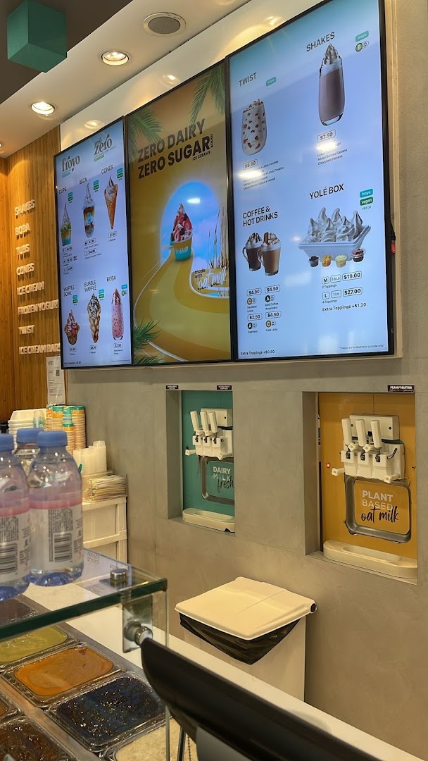 Interior view of Yolé Westgate, showcasing digital menus, self-serve frozen yogurt machines, and topping bar.