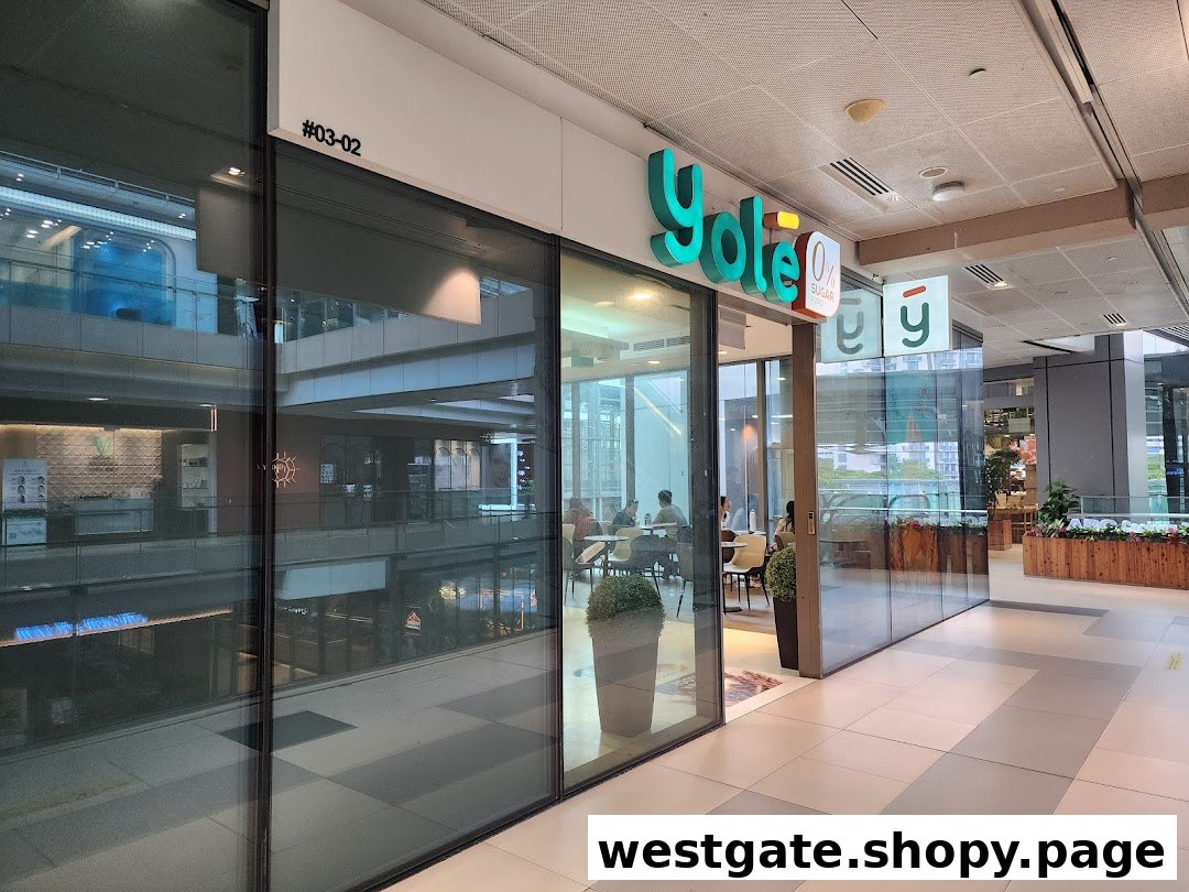 The glass storefront of Yolé Westgate, a frozen yogurt shop, featuring its prominent green logo and visible interior seating.