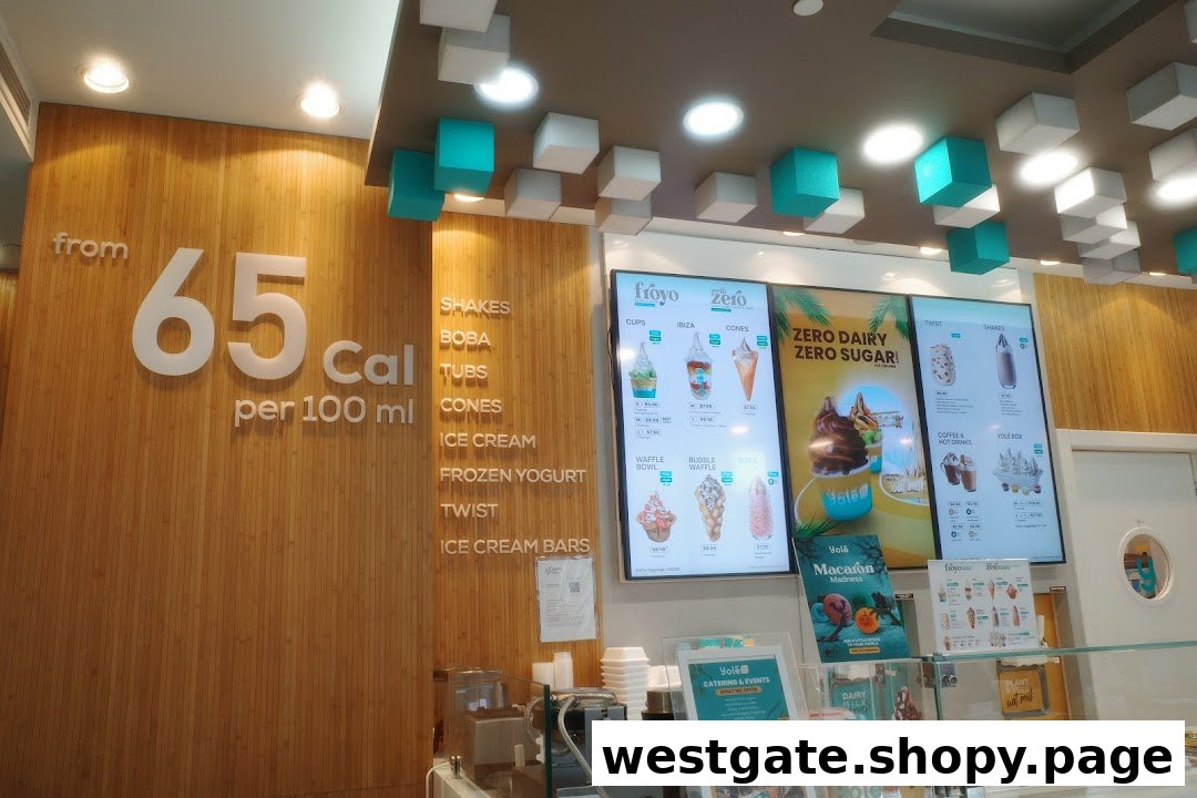 Interior view of Yolé Westgate, showcasing digital menus, counter, and calorie information.