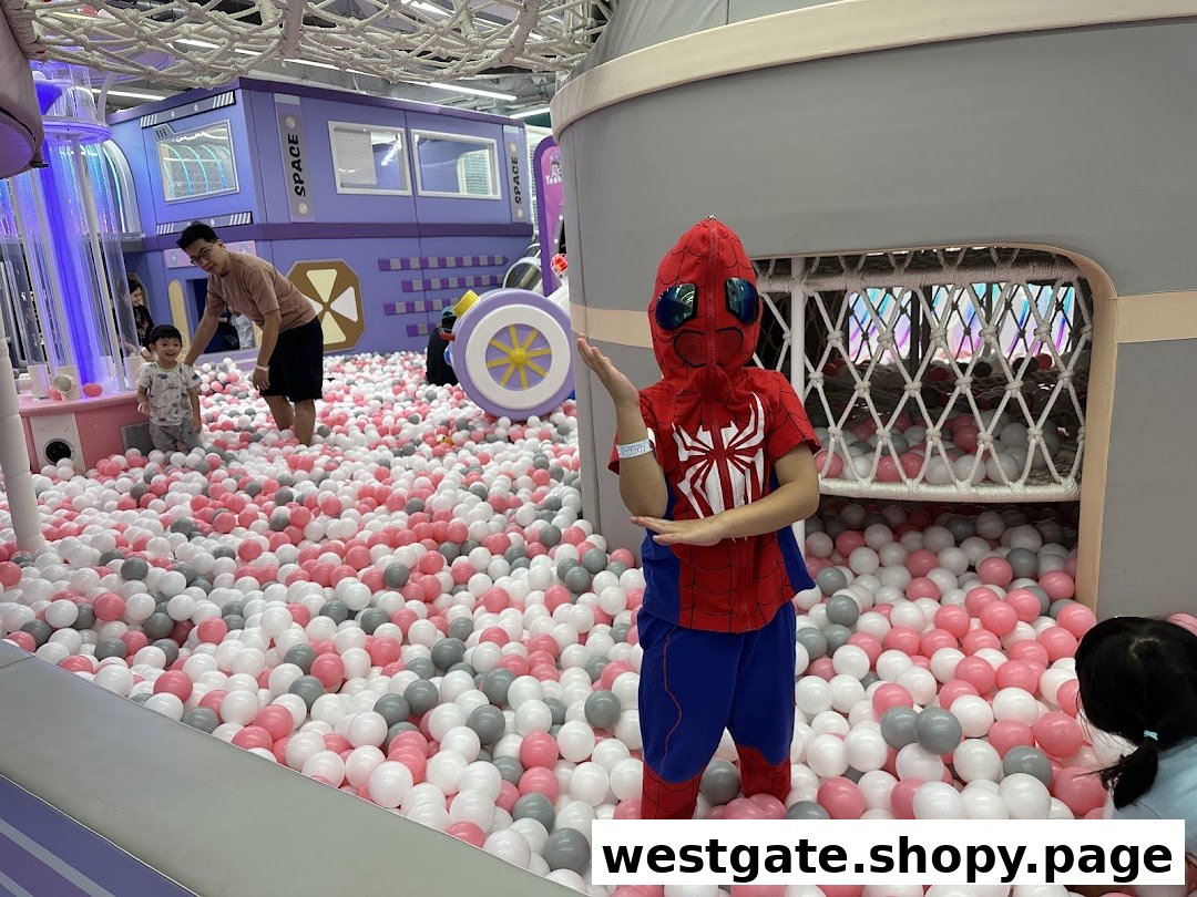 Children and adults enjoy a vibrant ball pit and play structures at Yooland's indoor playground.