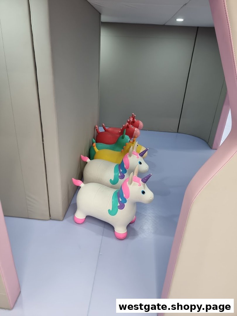 Colorful bouncy unicorn toys lined up in a soft play area at Yooland.